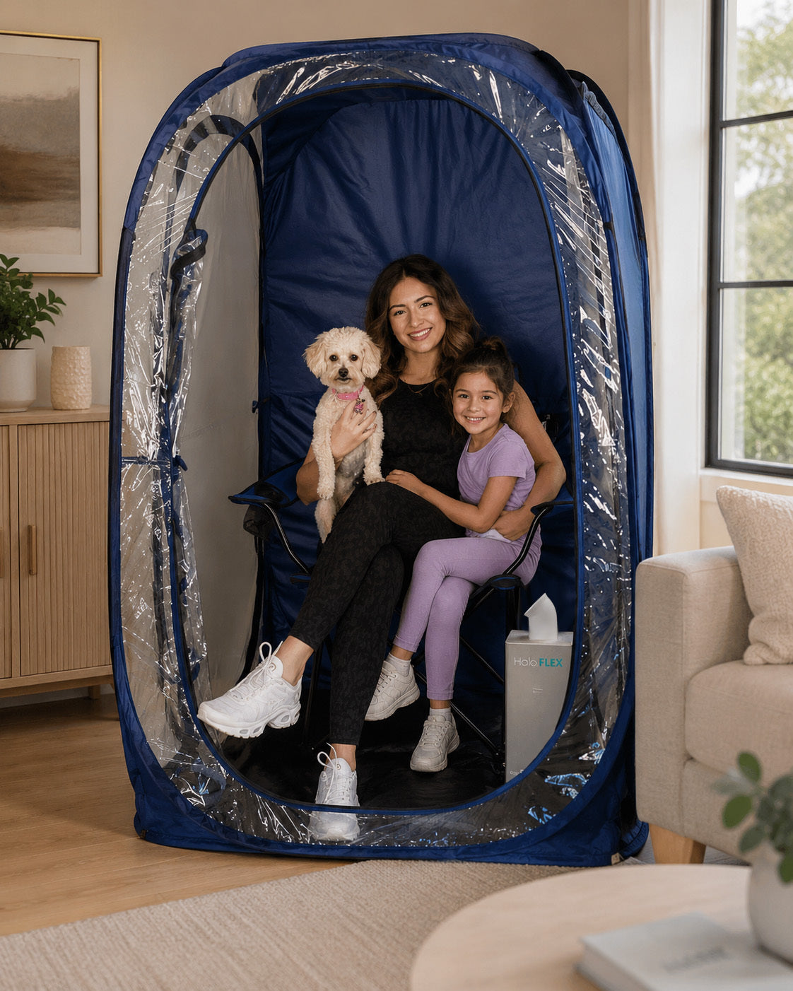 Woman and child with a dog inside a blue tent with HaloFLEX generator in a living room.