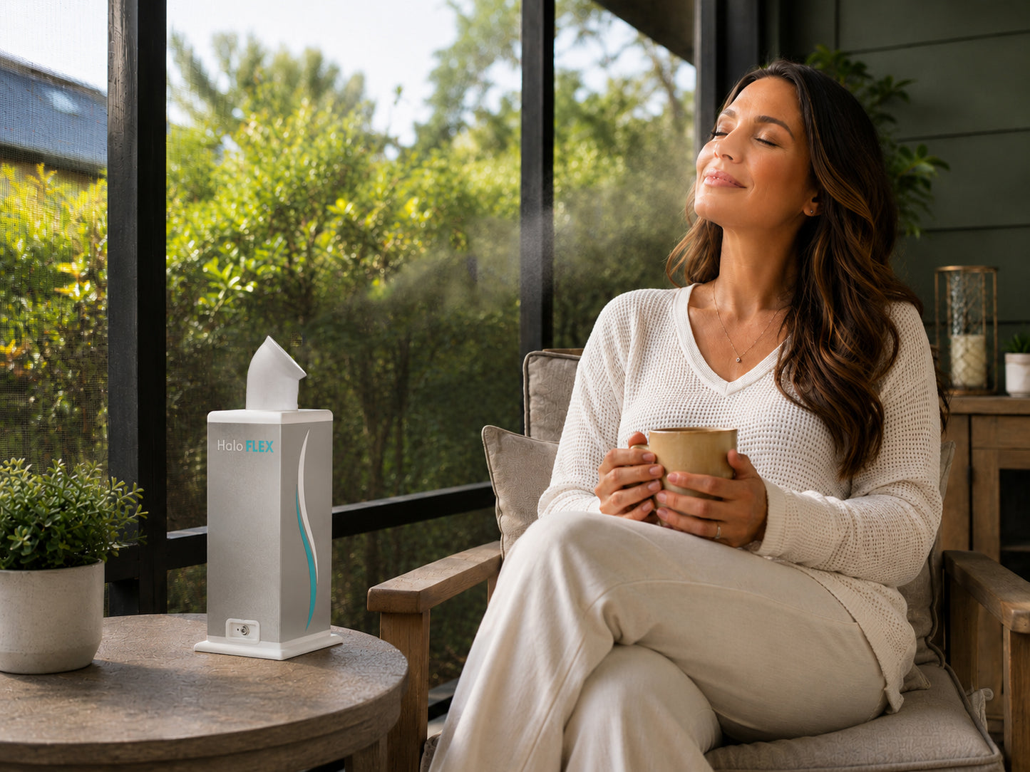 Woman sitting in a chair on a patio with the HaloFLEX generator operating on top of the table next to her.
